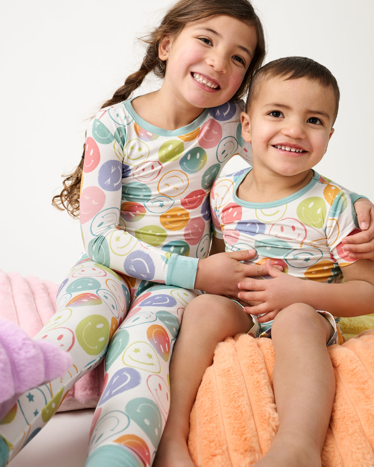 Two kids wearing matching Positive Vibes Two-Piece Pajama Sets