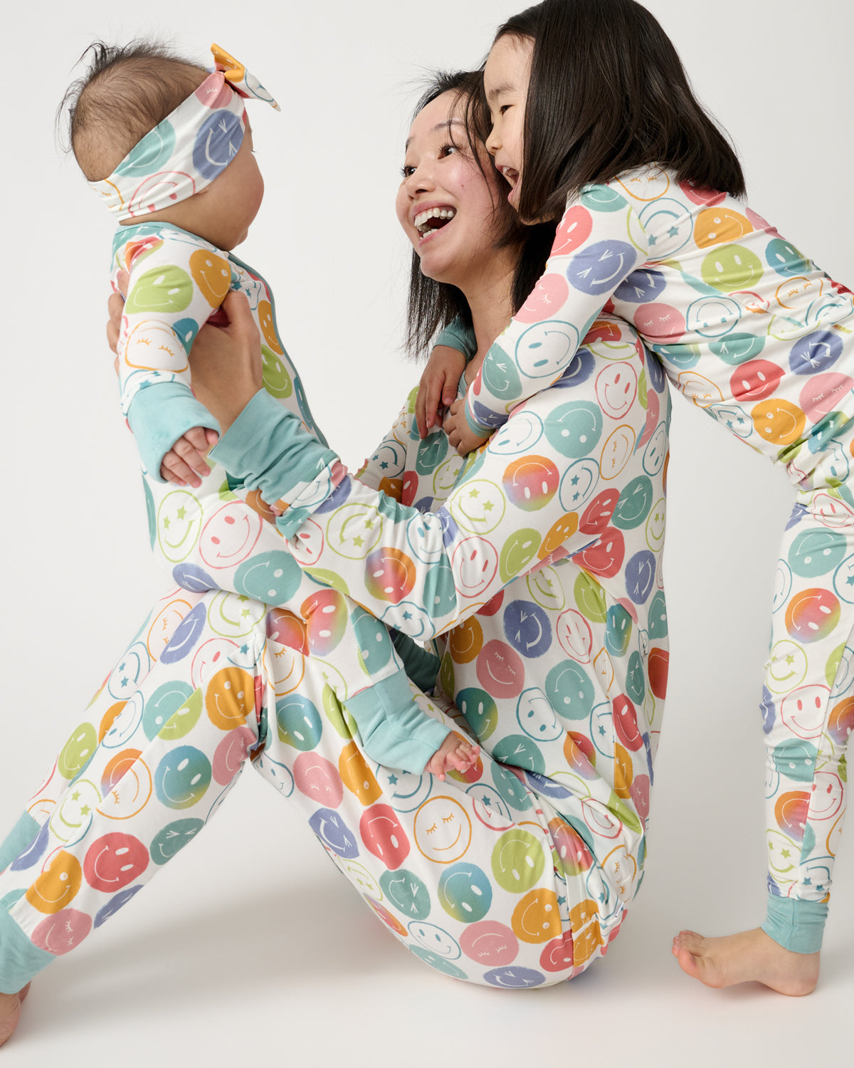 Mother and two children wearing matching Positive Vibes pajamas