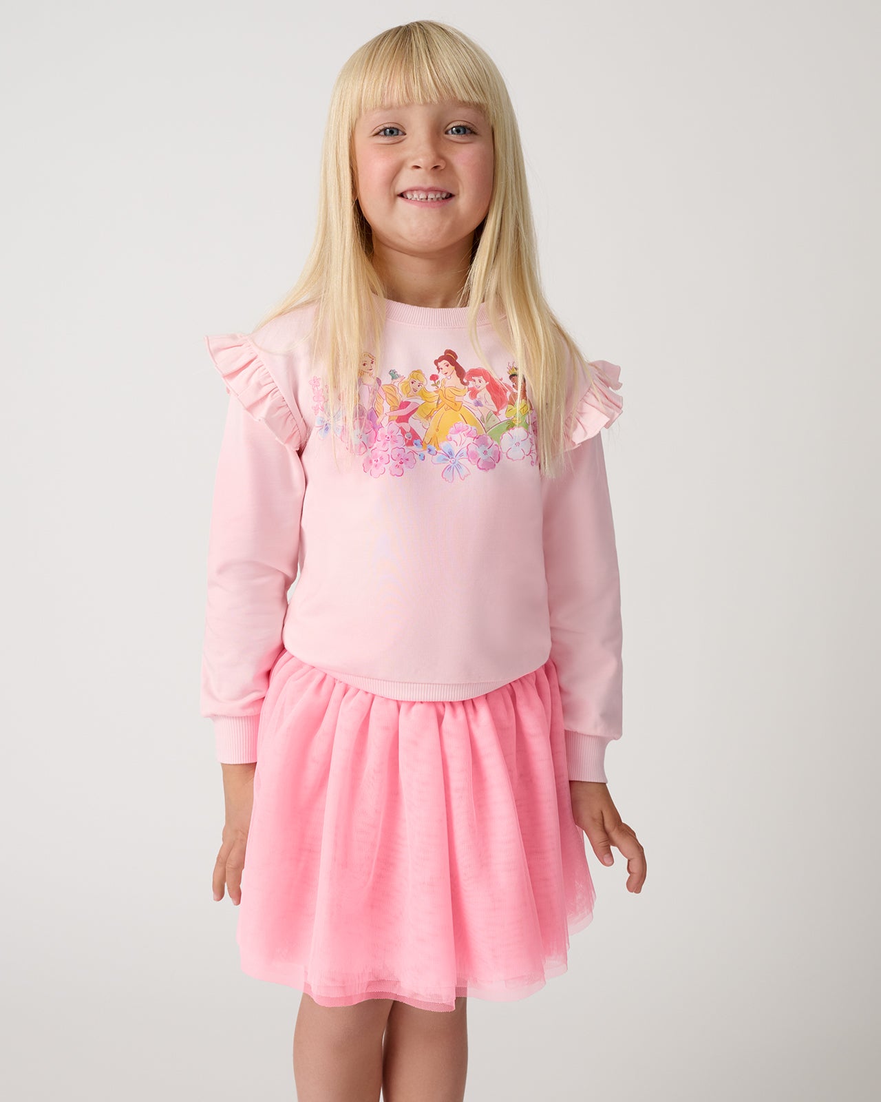 Girl wearing the Precious Pink Tutu Skirt with a Disney Princess sweatshirt