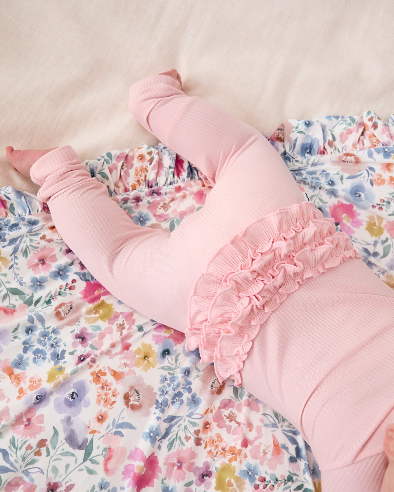 Close up of the ruffle detail on the Prima Pink Ribbed Ruffle Zippy