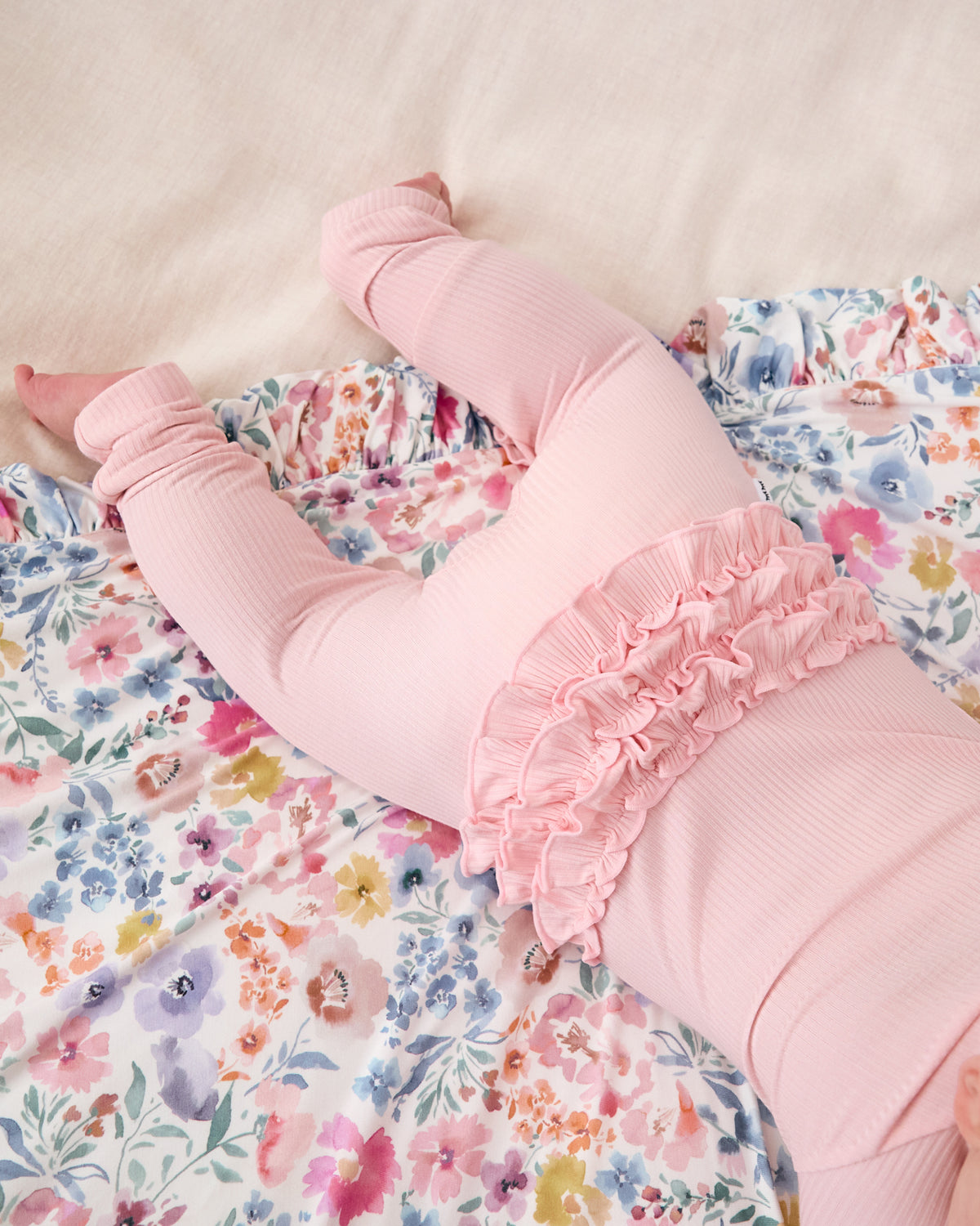 Close up of the ruffle detail on the Prima Pink Ribbed Ruffle Zippy