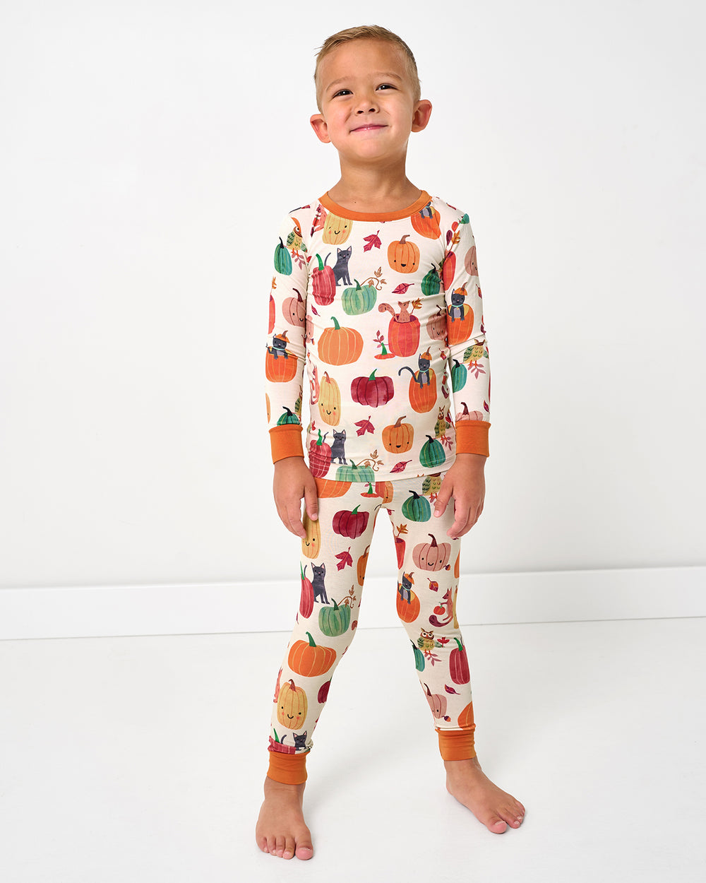 Standing child wearing the Pumpkin Pals Two-Piece Pajama Set