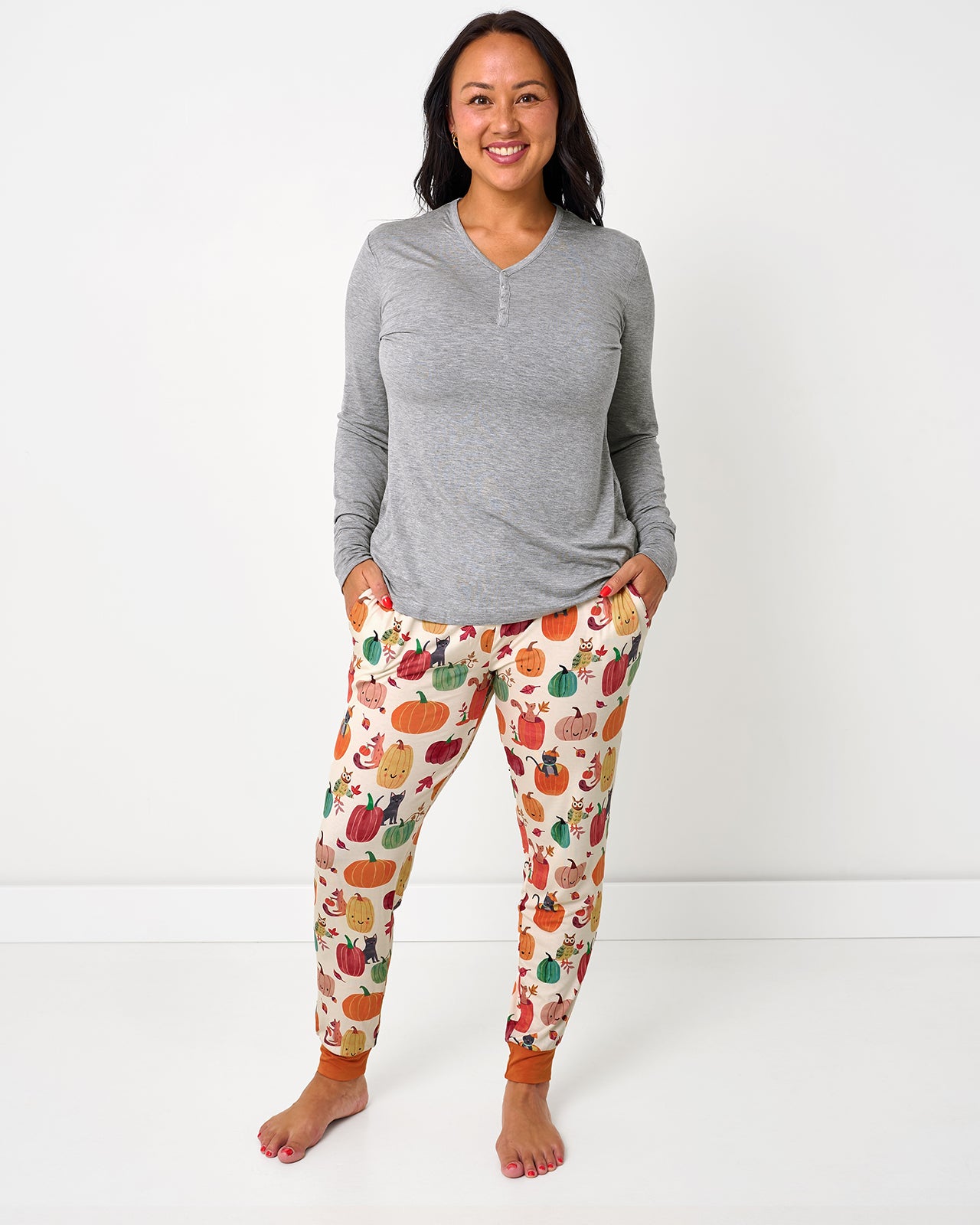 Woman wearing the Pumpkin Pals Women's Pajama Pants with a gray pj top