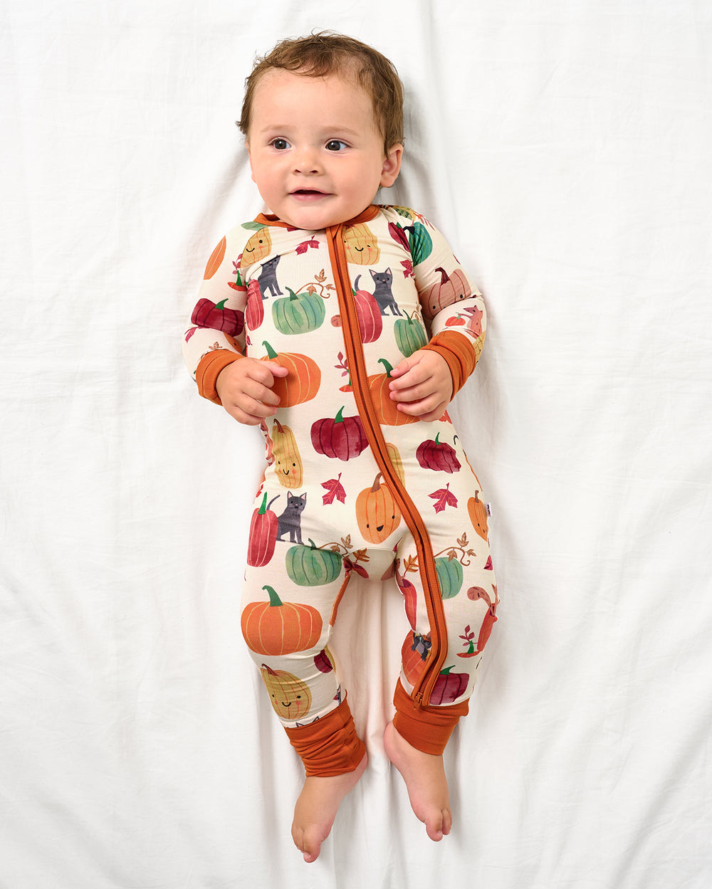Baby wearing the Pumpkin Pals Zippy