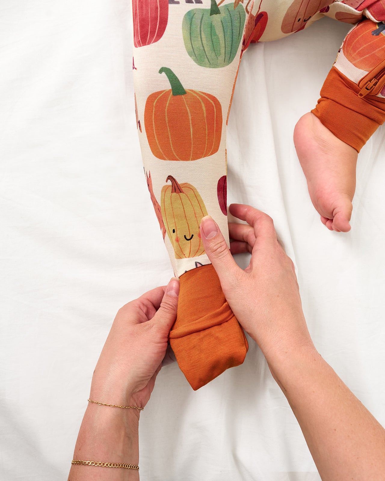 Adult demonstrating the foot fold over feature on the Pumpkin Pals Zippy