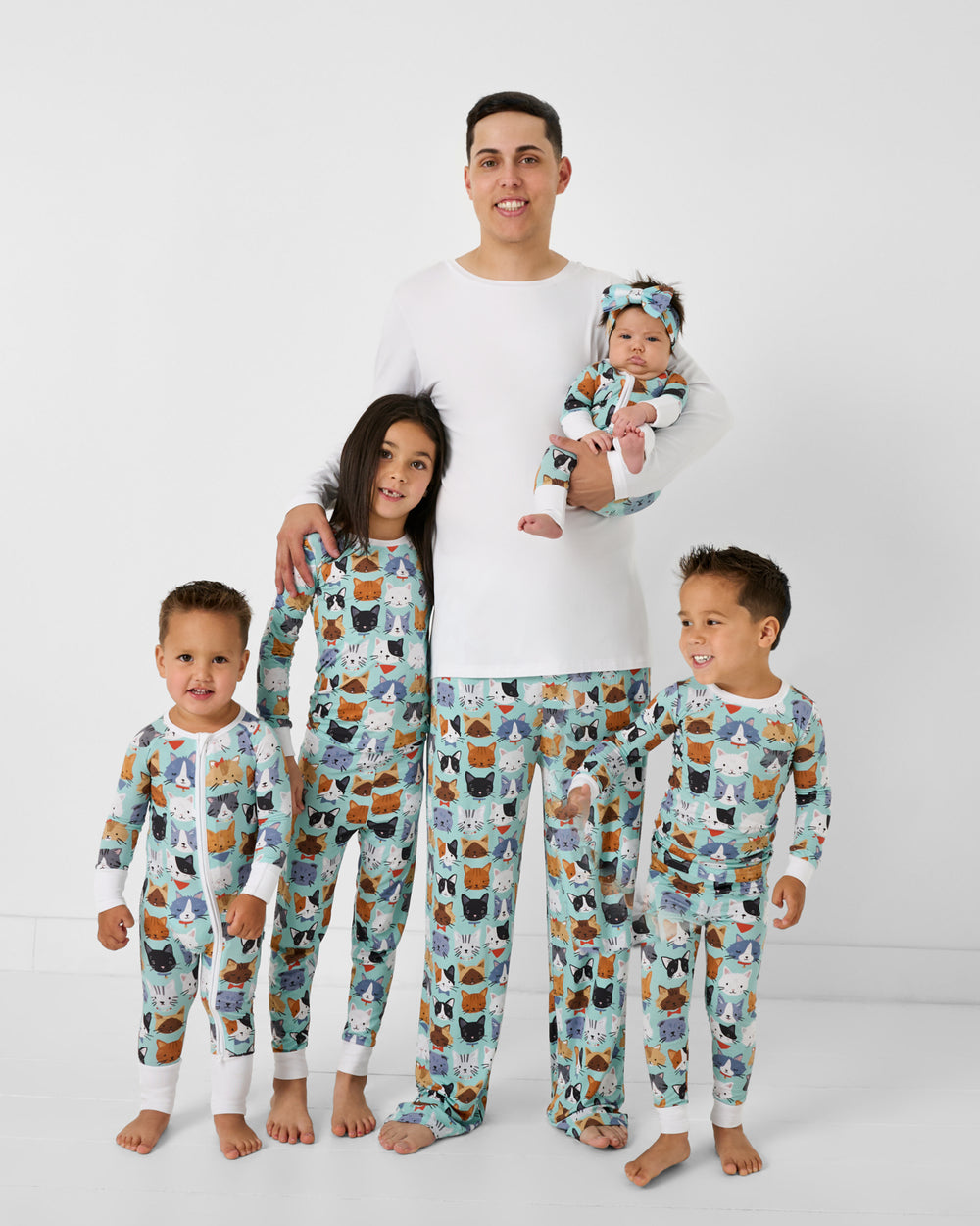 Father and four children wearing matching Purrfect Pals bamboo cat pajamas