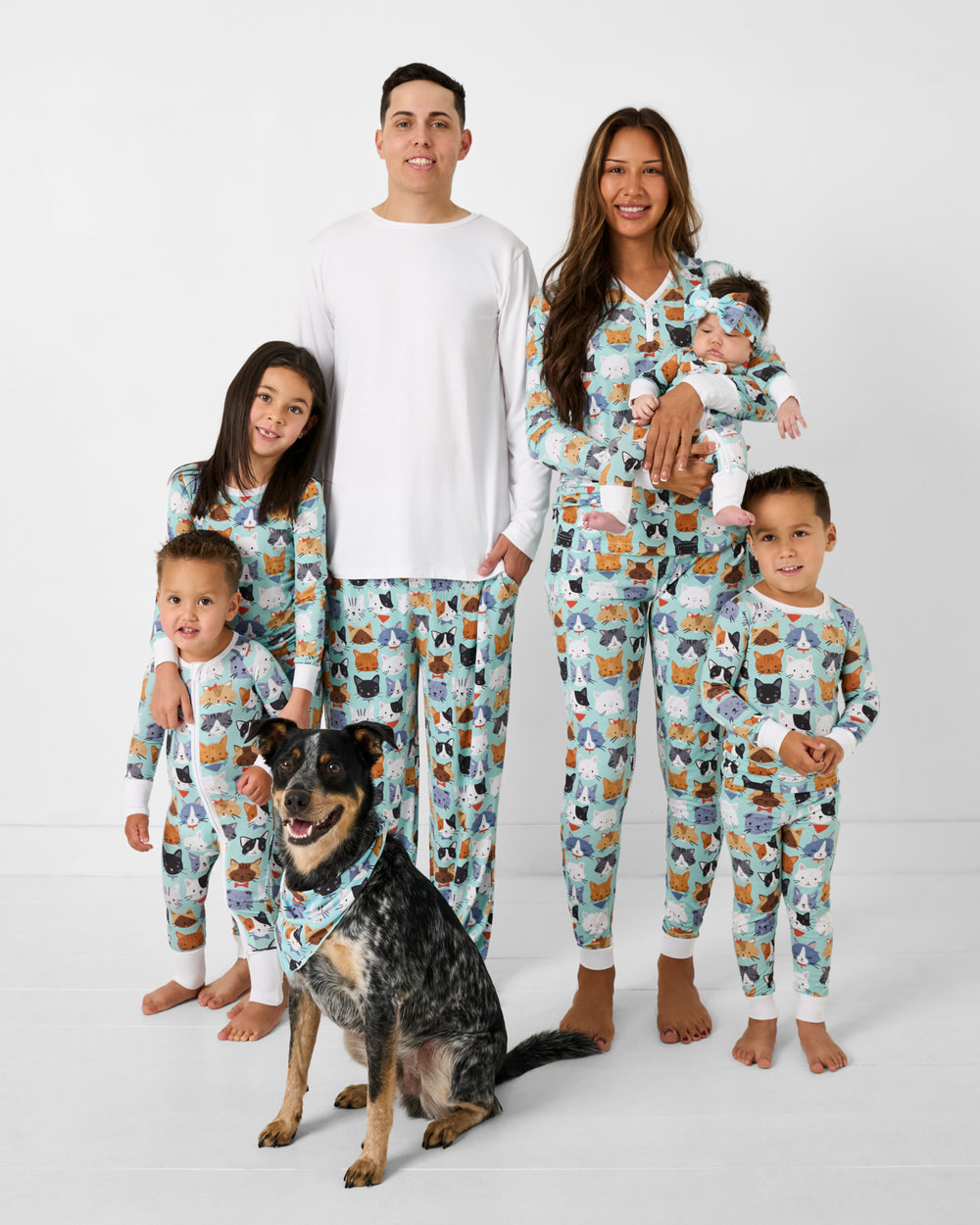 Family of six and a dog wearing matching Purrfect Pals bamboo cat pajamas