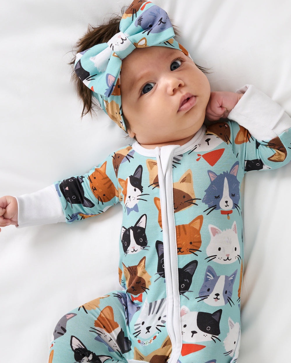 Aerial view of baby wearing the Purrfect Pals Luxe Bow Headband
