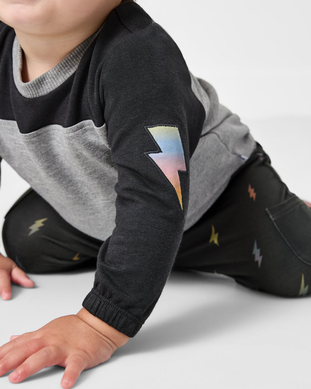 Close up of the lightning bolt icon on the Rad Bolts Cinched Panel Crewneck