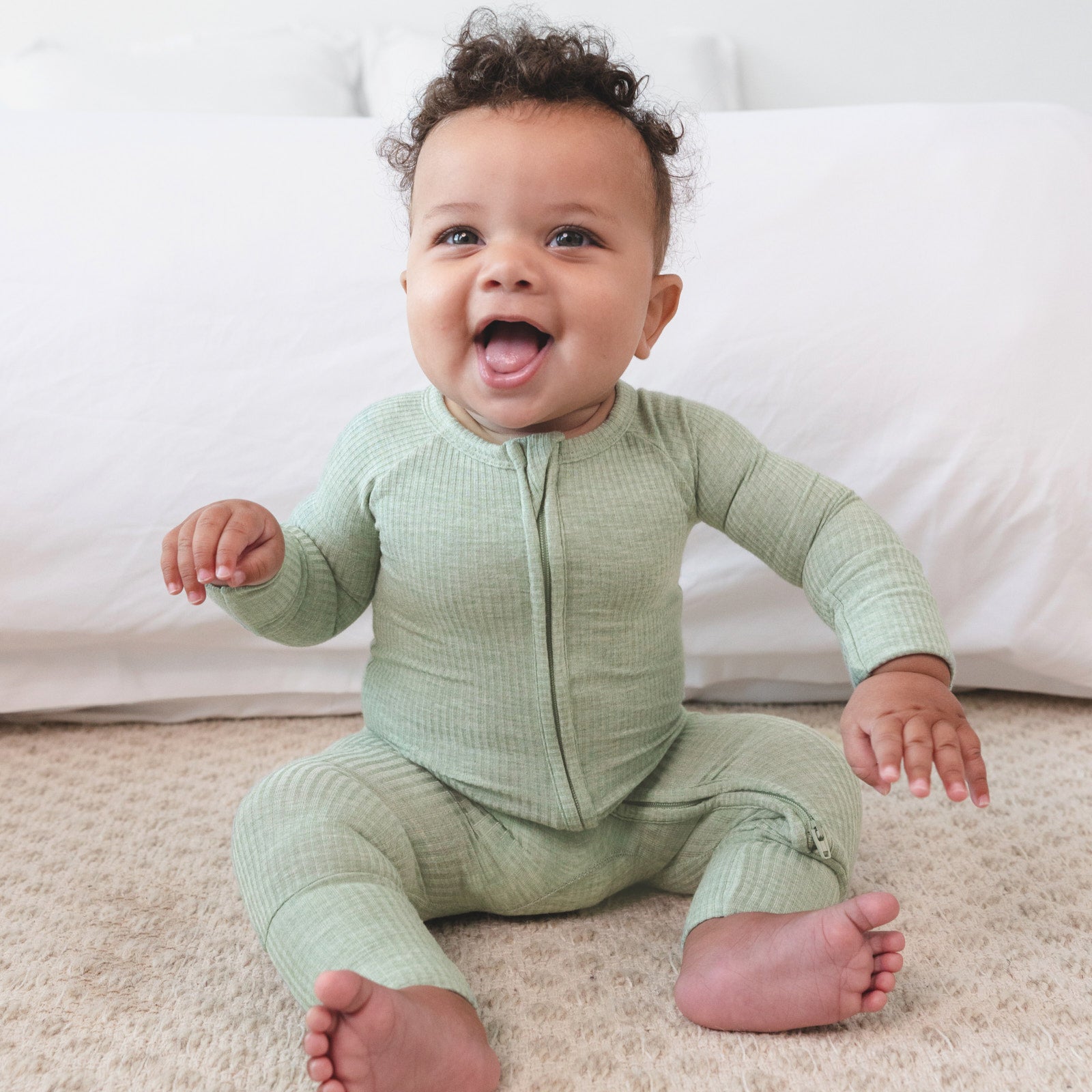 baby laughing wearing the heather sage zippy