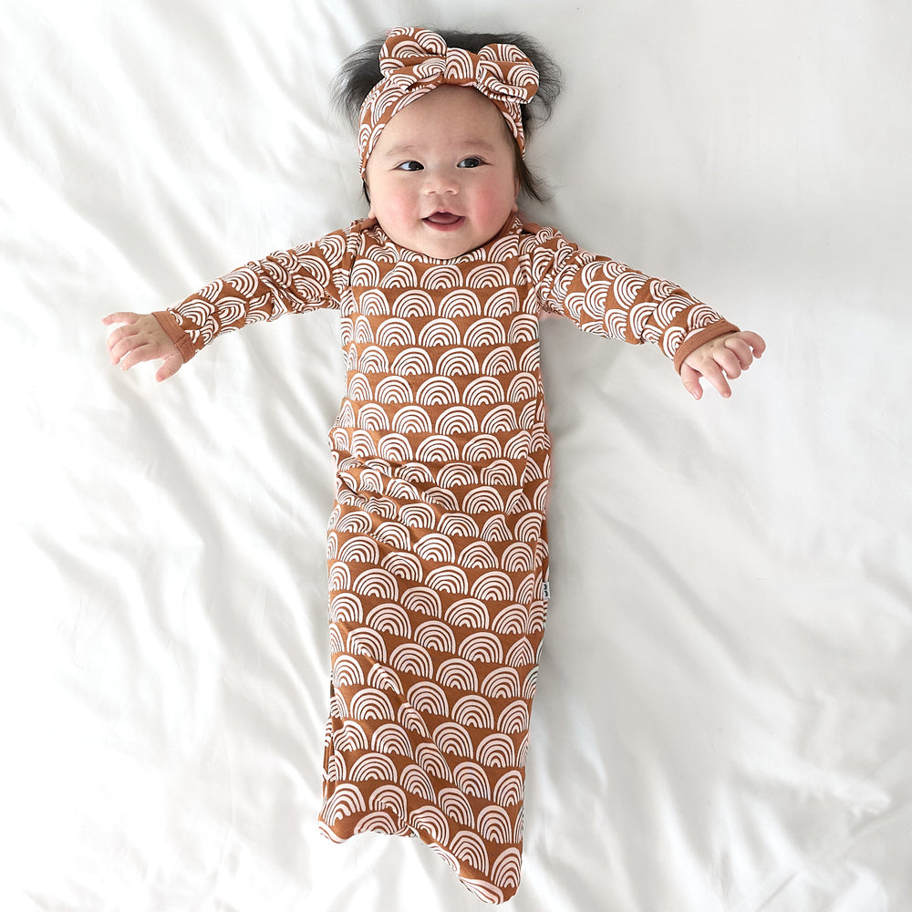 baby wearing rust rainbows gown and luxe bow