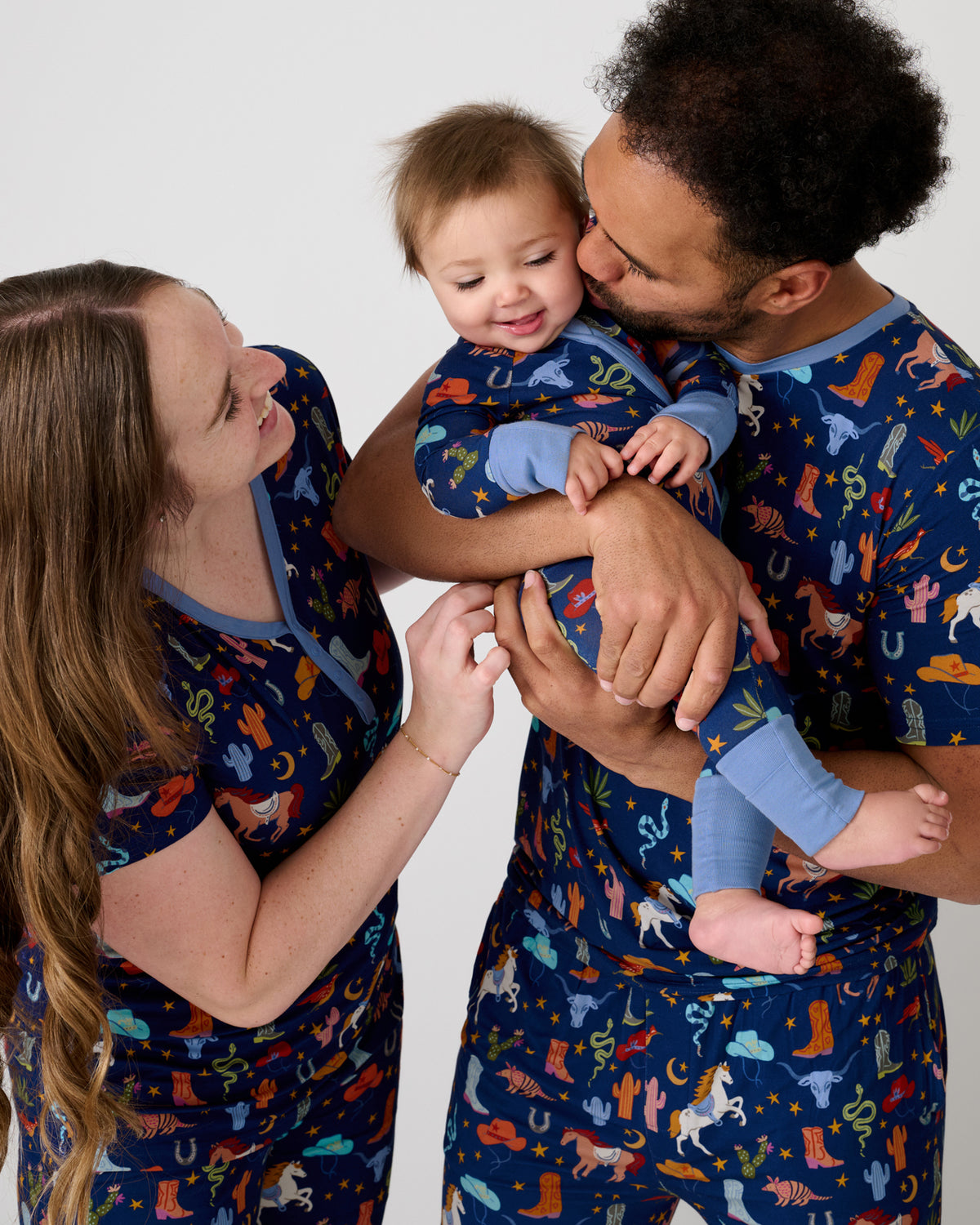Family of three wearing matching Blue Rancher Roundup pajamas