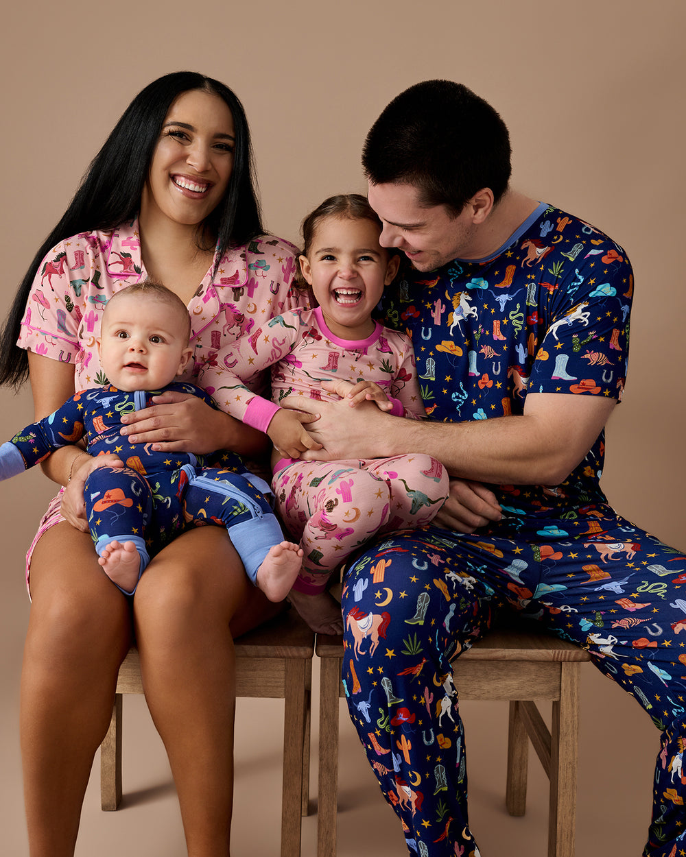 Family of four wearing Pink and Blue Rancher Roundup pajamas