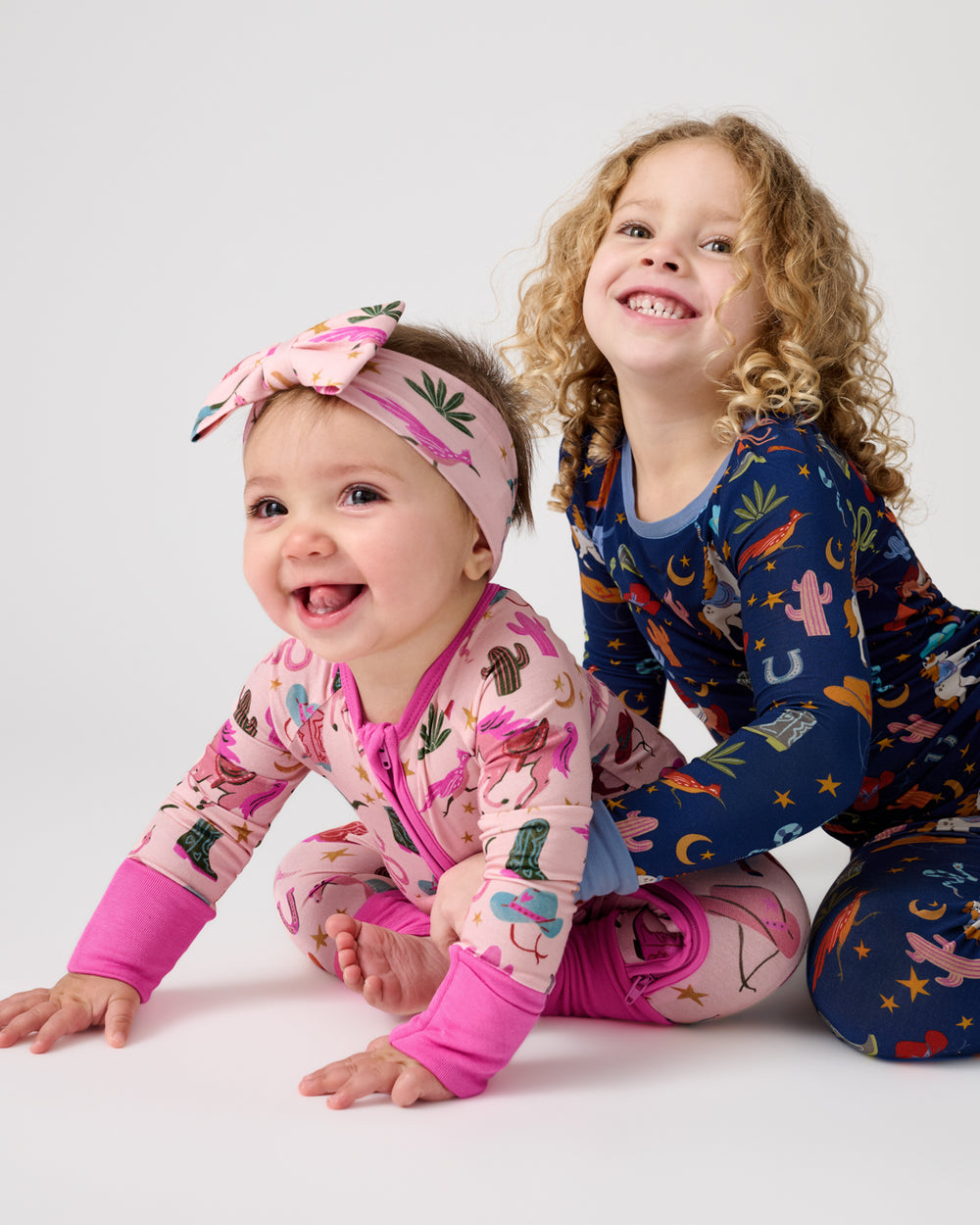 Two children wearing Rancher Roundup western print pajamas