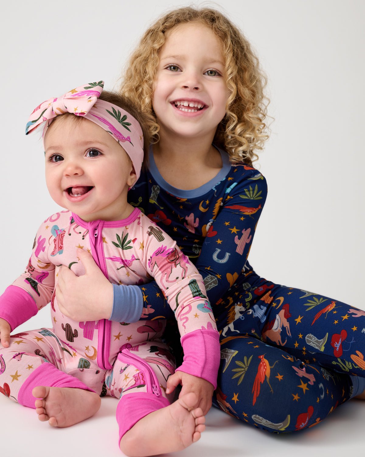 Two children wearing matching Rancher Roundup print pajamas