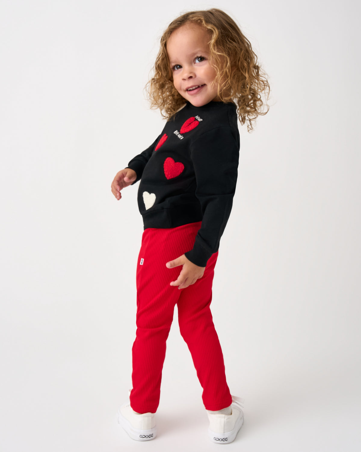 Standing girl wearing the Candy Red Ribbed Legging