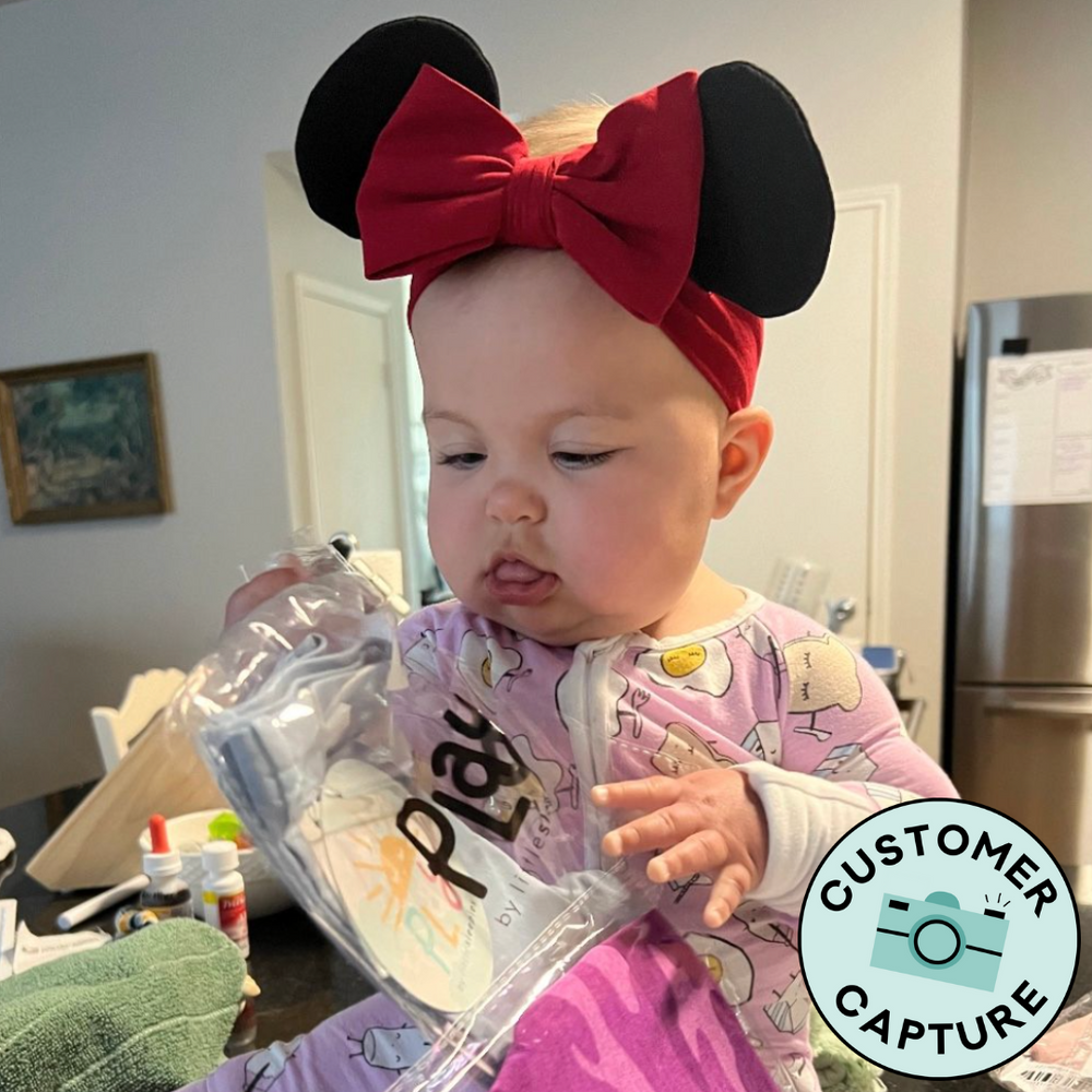 Customer Capture image of a child wearing a Disney Minnie Luxe Bow headband