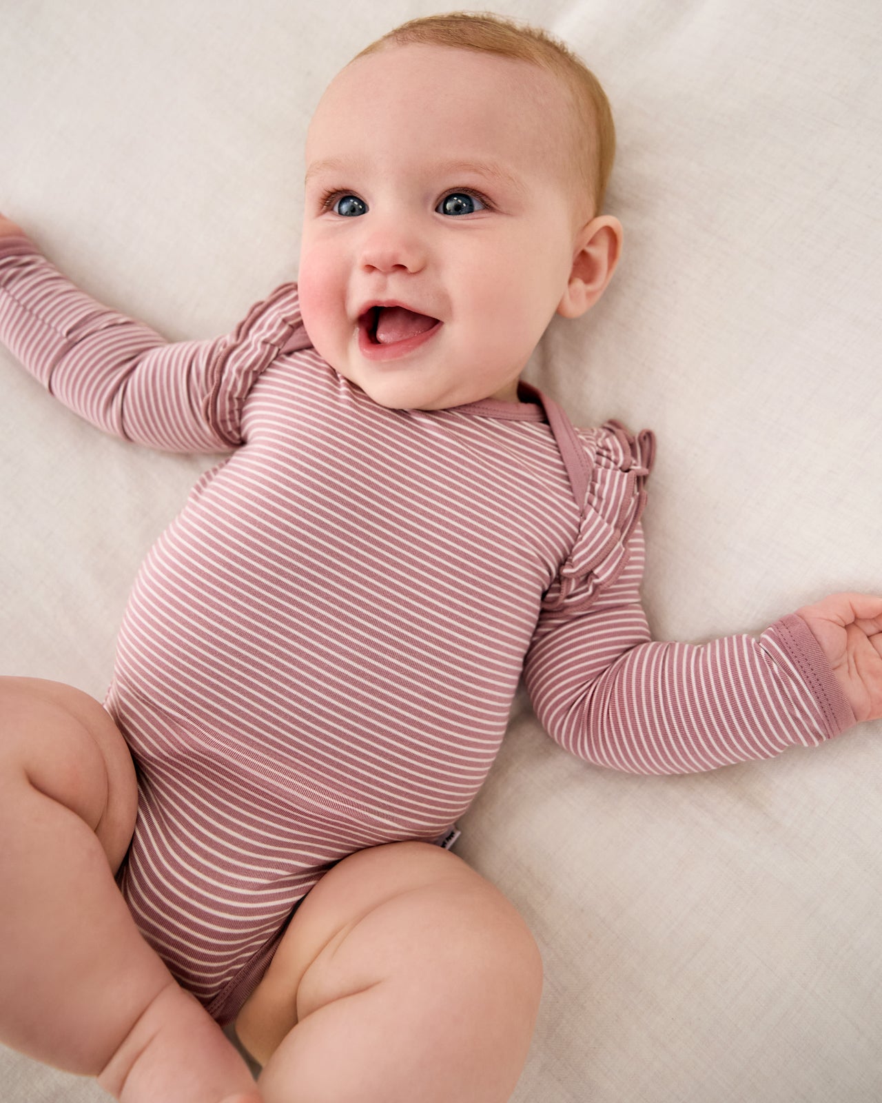 Newborn wearing the Rosewood Stripe Flutter Bodysuit
