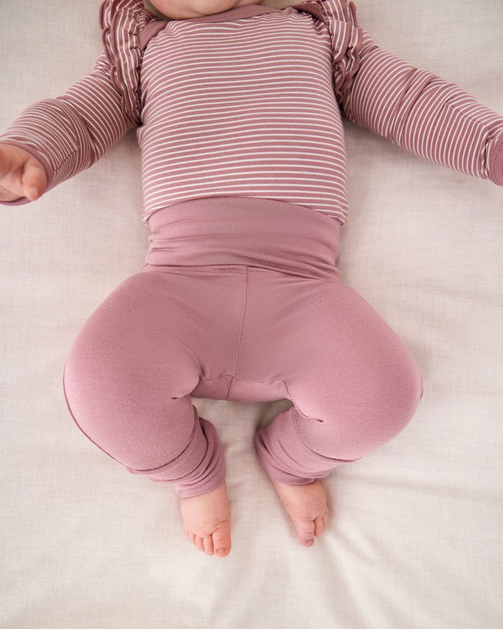 Newborn wearing the Rosewood Fold-Over Legging