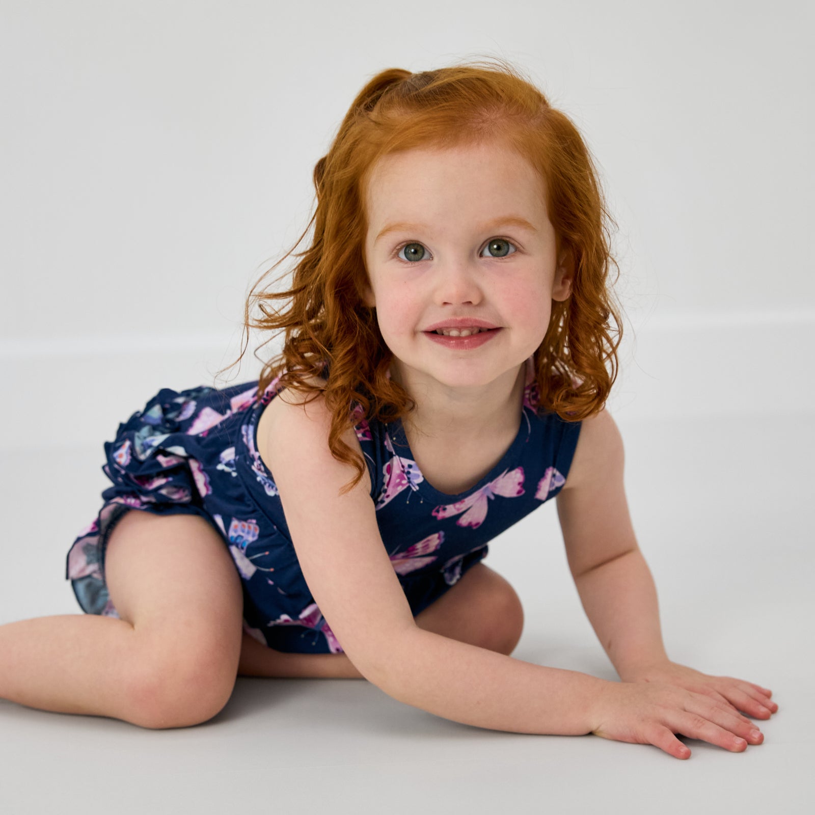 Crawling child wearing the Royal Butterflies Bubble Romper