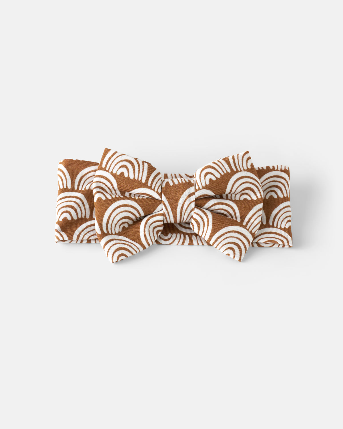 Flat lay of the Rust Rainbows Luxe Bow Headband