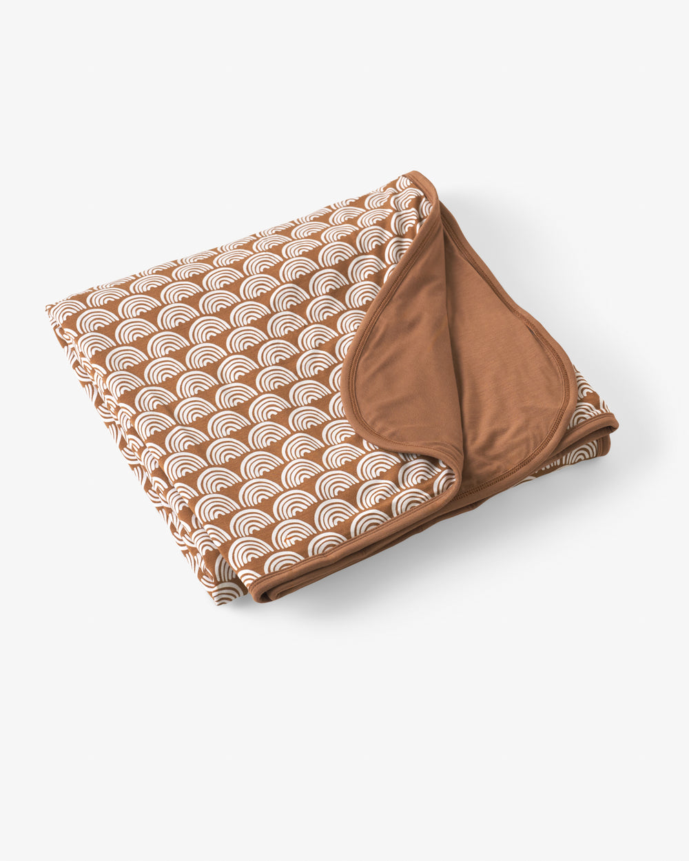 Flat lay of the Rust Rainbows Large Cloud Blanket®