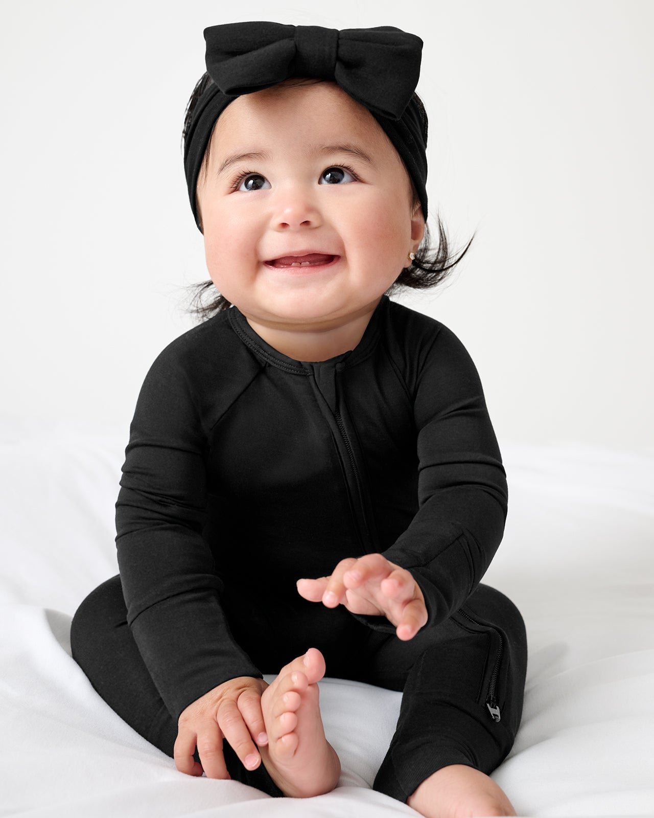 Baby wearing the Black Luxe Bow Headband and Zippy PJ