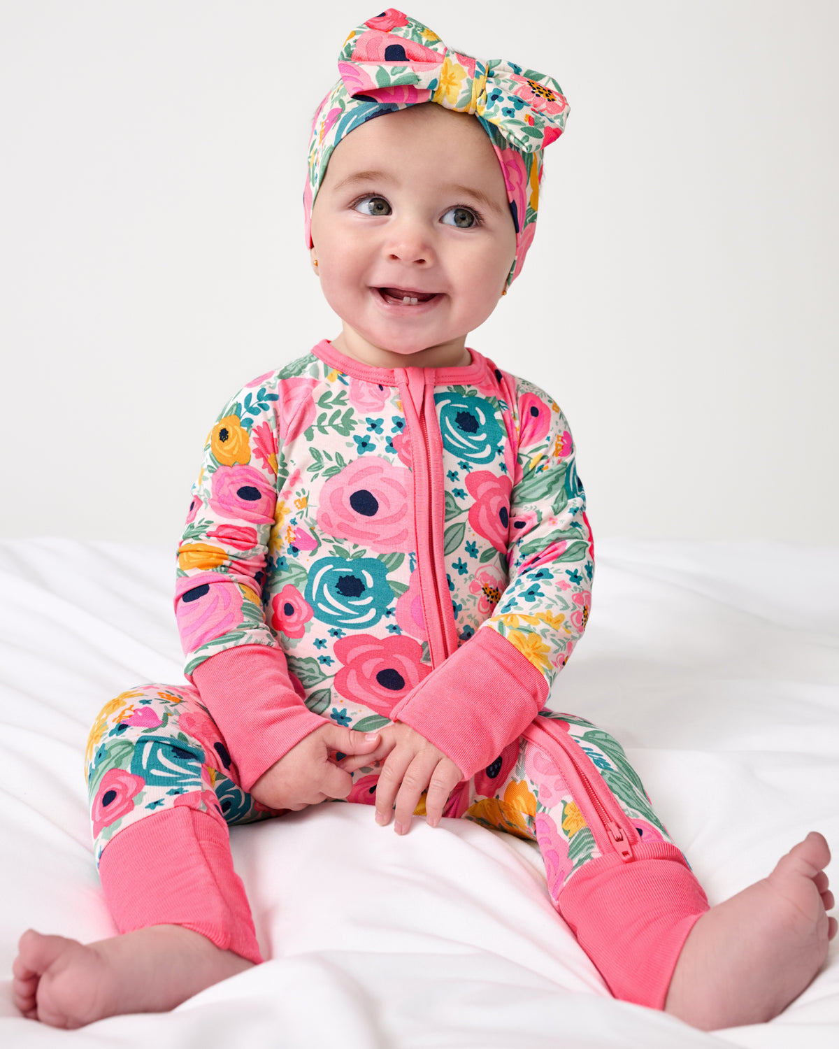 Sitting baby wearing the Secret Garden Zippy and Luxe Bow Headband