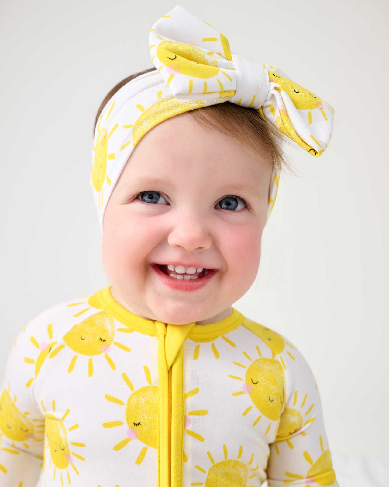 Close up of baby girl wearing the Sunshine Luxe Bow Headband