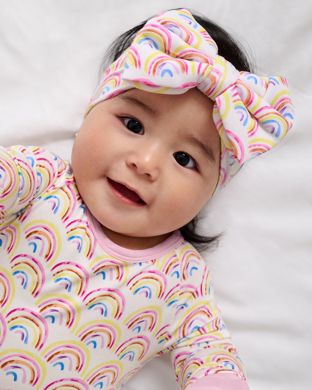 Baby wearing the Pastel Rainbows Luxe Bow Headband