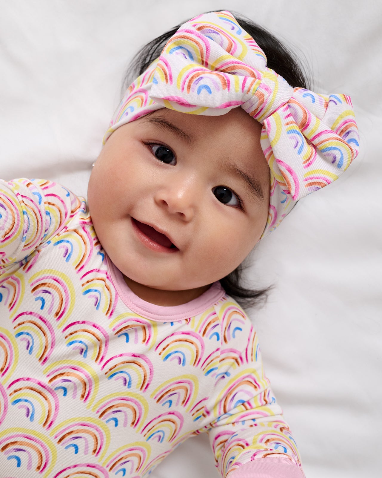 Baby wearing the Pastel Rainbows Luxe Bow Headband