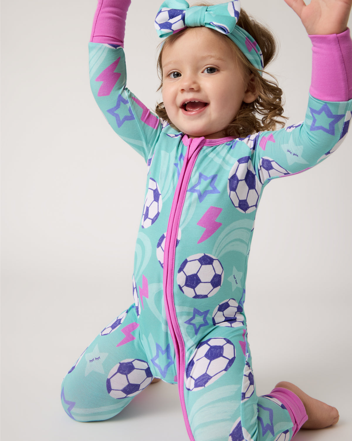 Posing child wearing the Aqua Soccer Stars Zippy and Headband