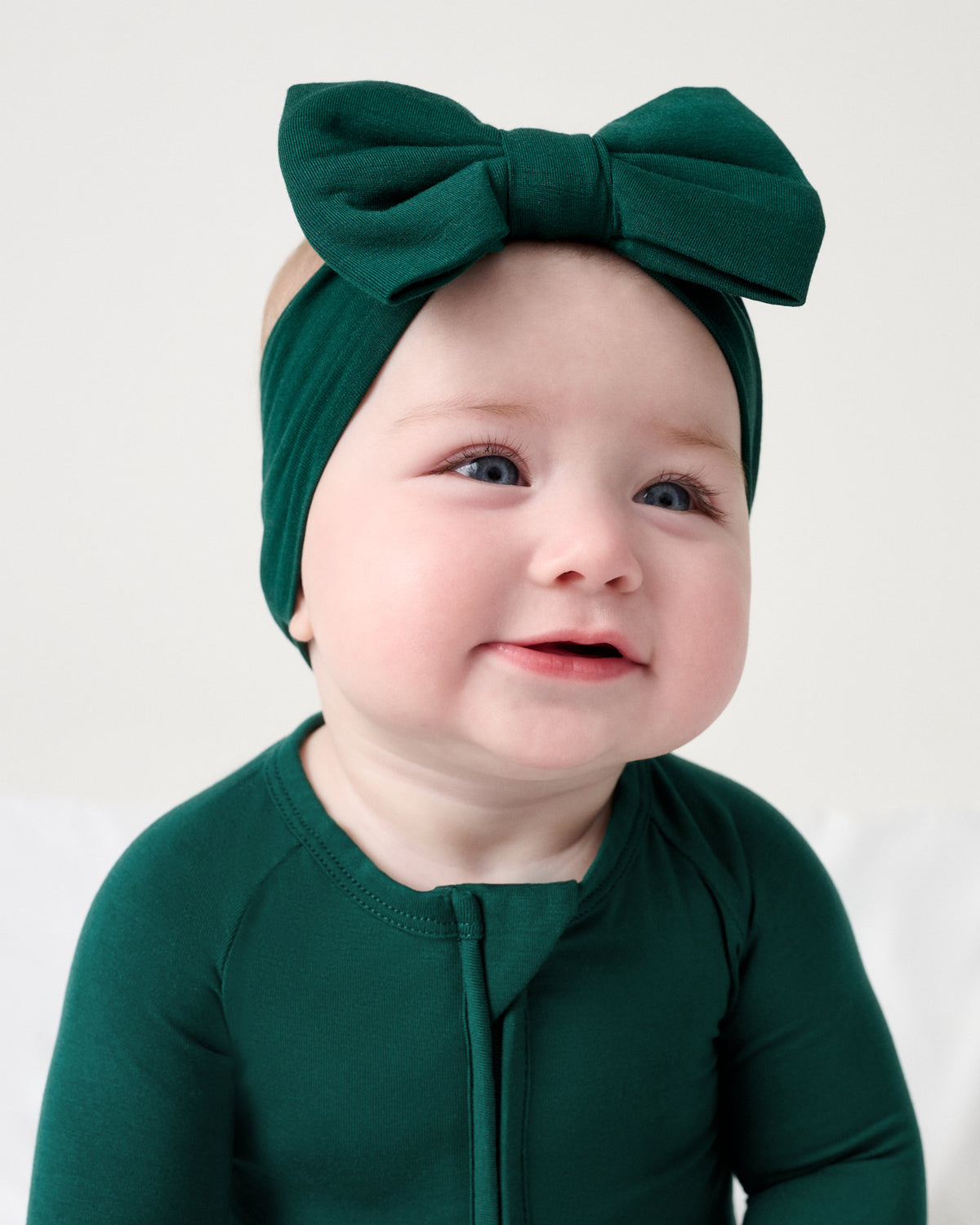 Newborn wearing the Emerald Luxe Bow Headband