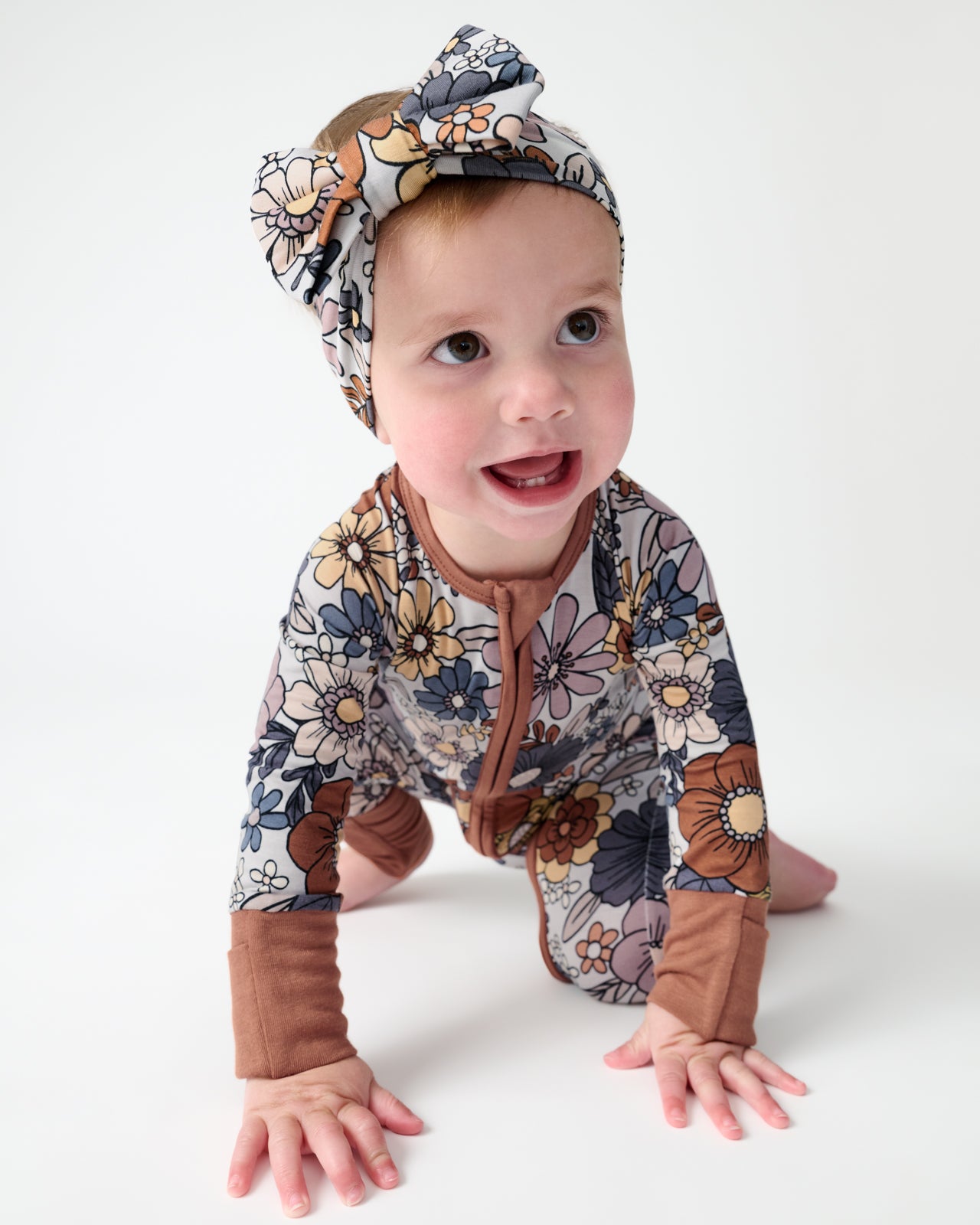 Crawling baby wearing the Wildwood Floral Luxe Bow Headband and Zippy