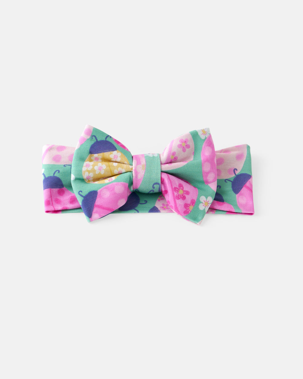 Flat lay of the Ladybug Meadow Luxe Bow Headband