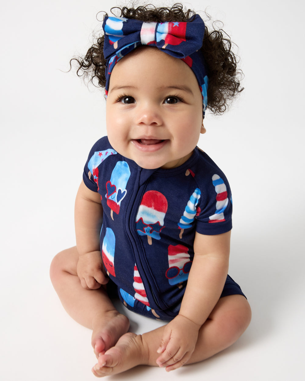 Sitting baby wearing the Sparkle Treats Luxe Bow Headband