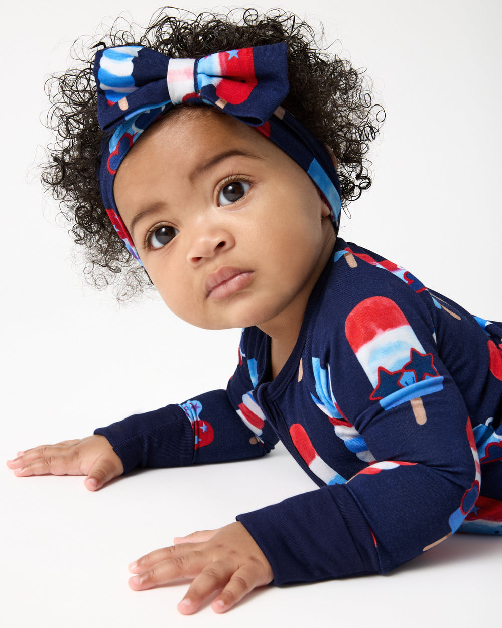 Baby wearing the Sparkle Treats Luxe Bow Headband and Zippy