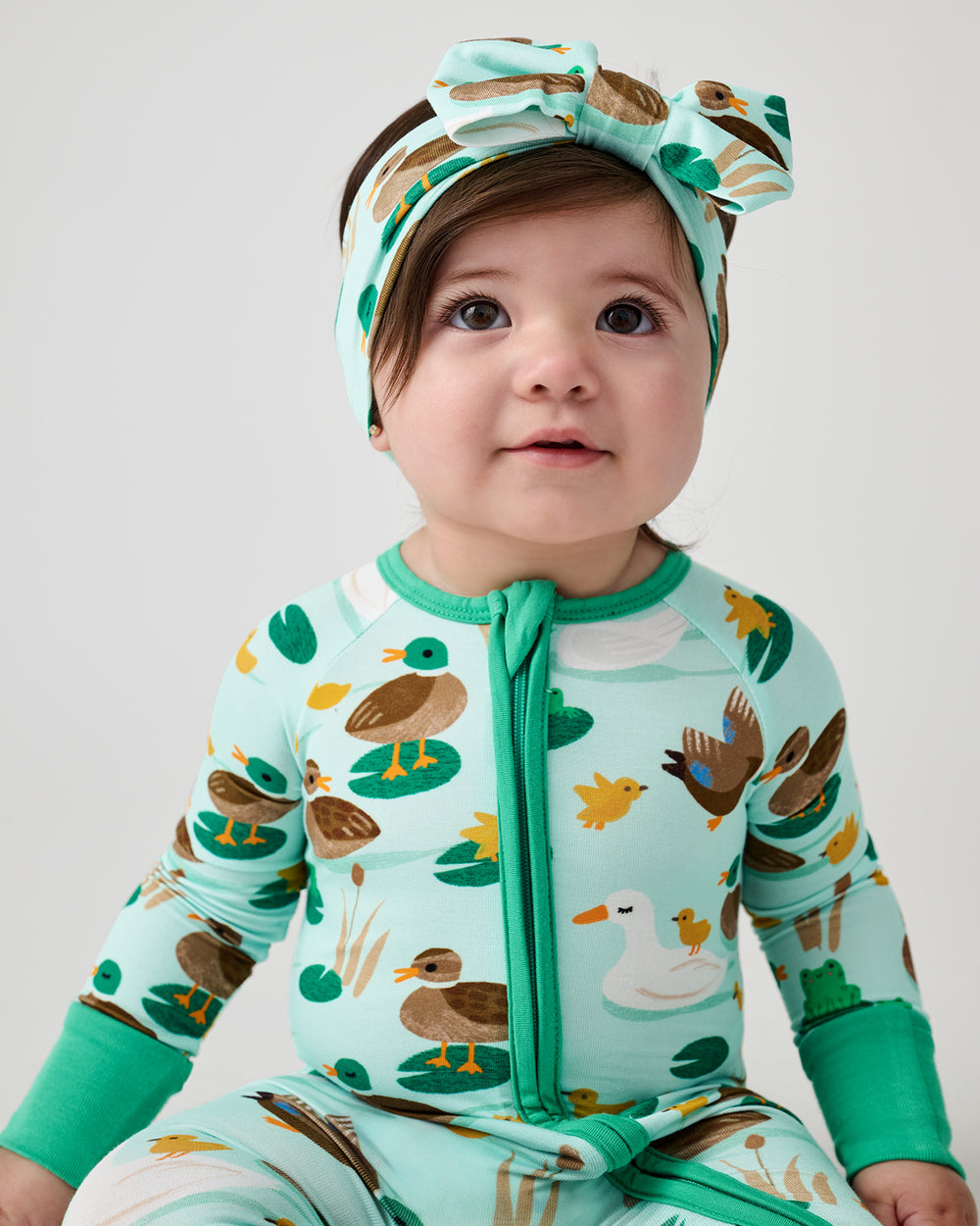 Baby wearing the Puddle Jumpers Luxe Bow Headband