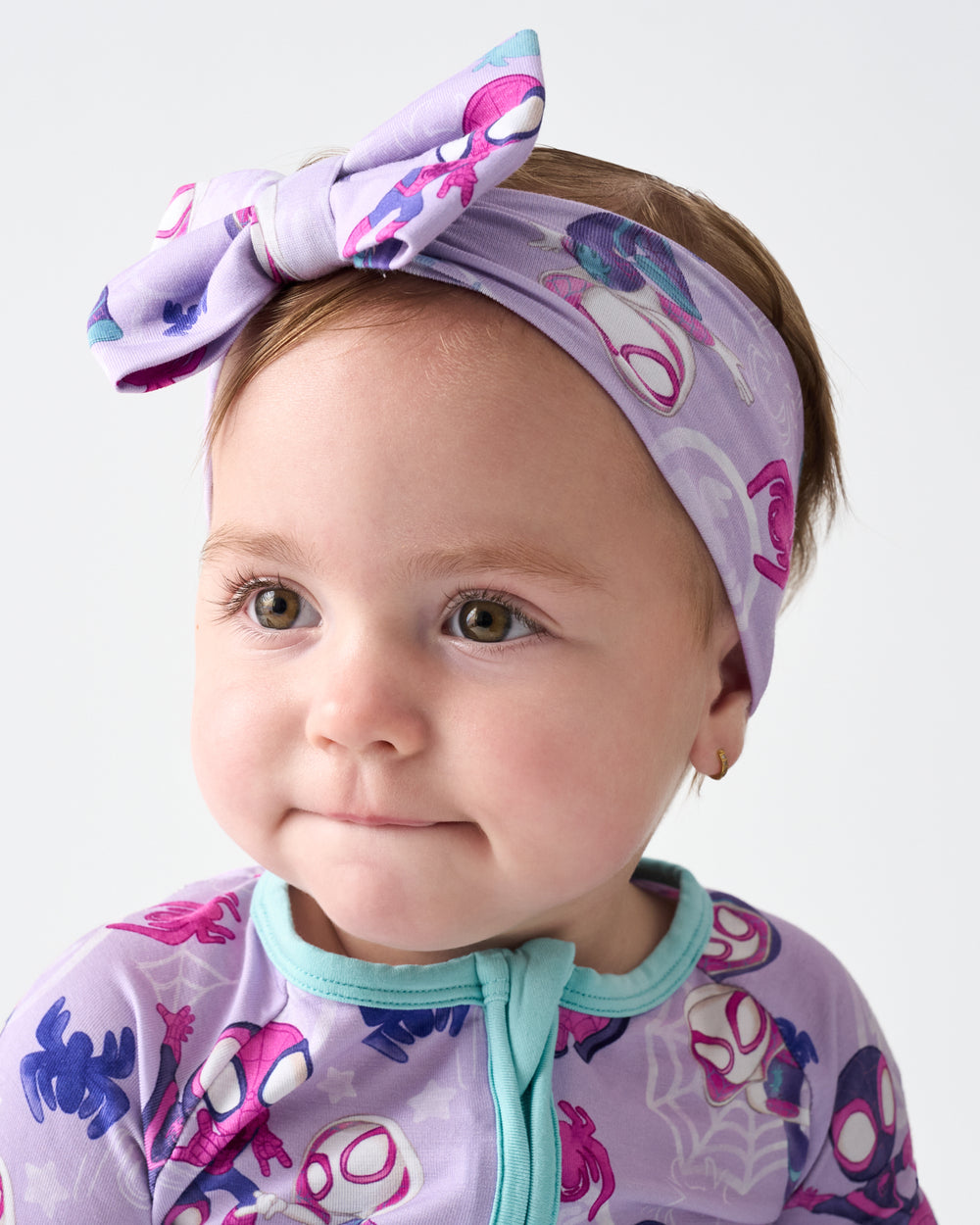 Close up of baby wearing the Spidey & Friends Tiny Webs Luxe Bow Headband