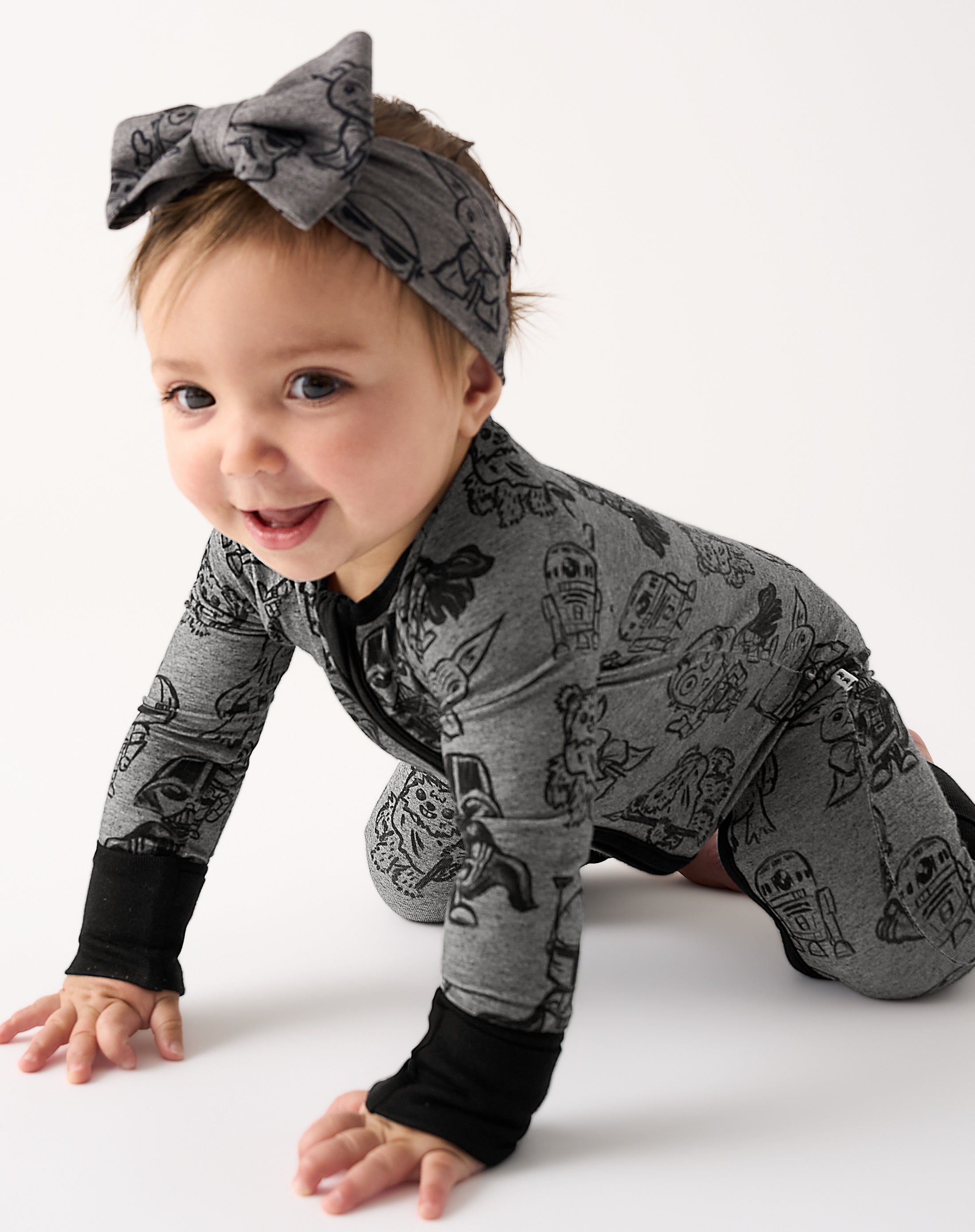 Crawling baby wearing the Star Wars Far, Far, Away Friends Zippy and Luxe Bow