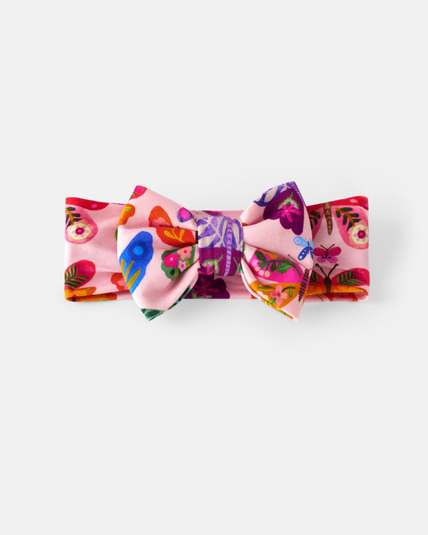 Flat lay of the Flutter Garden Luxe Bow Headband