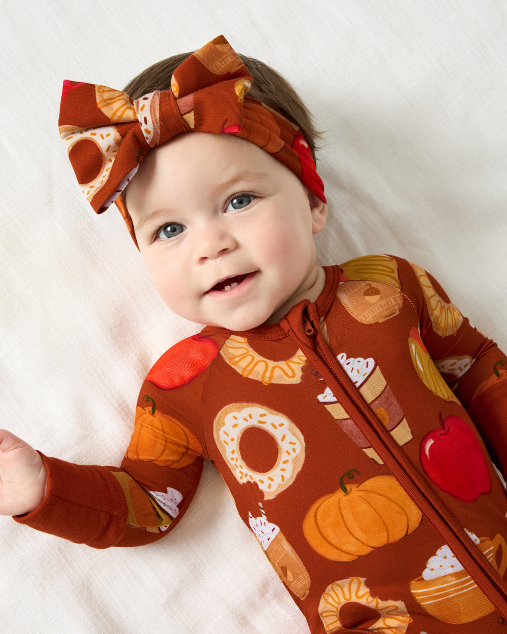 Aerial view of baby wearing the Harvest Sweets Luxe Bow Headband