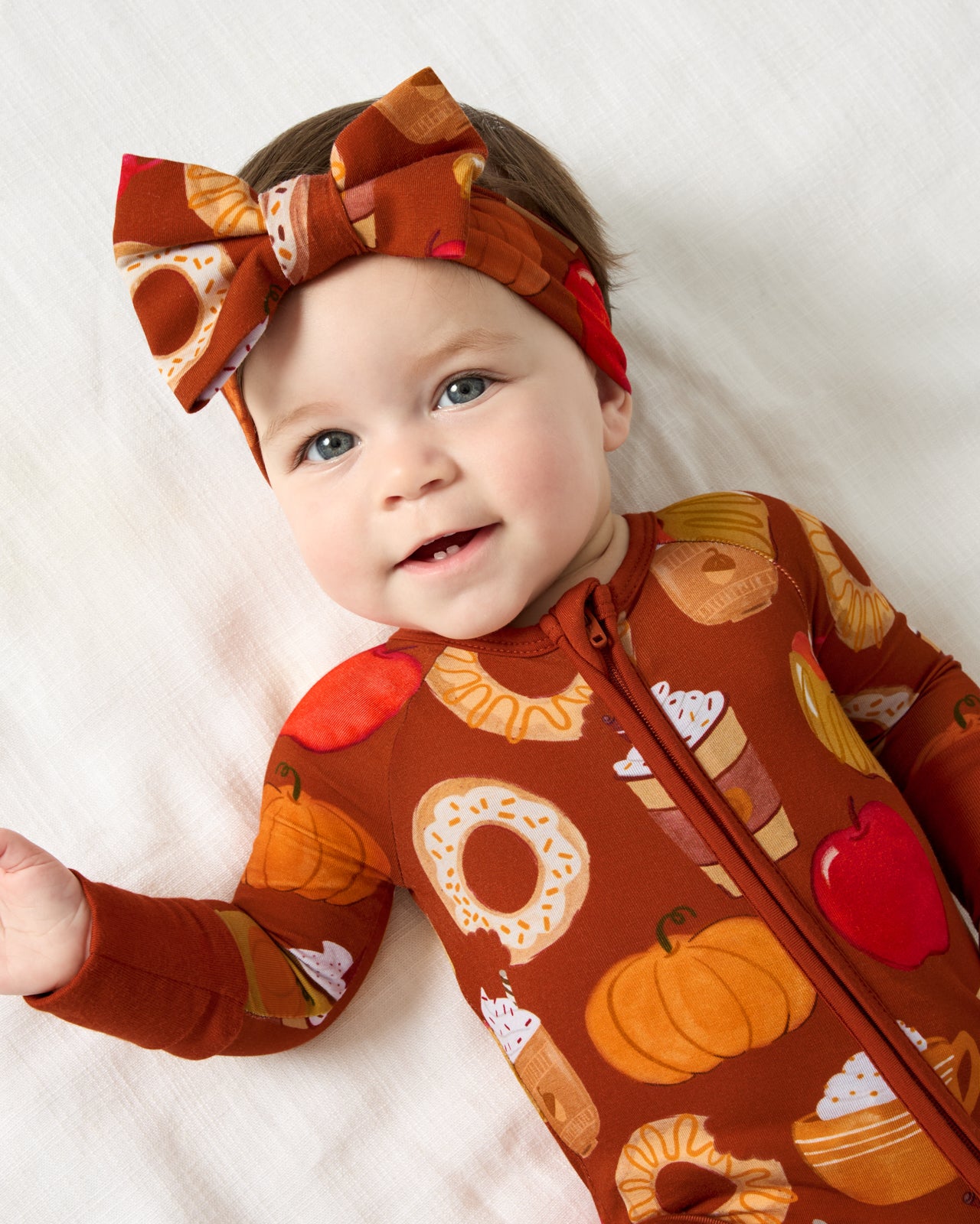 Aerial view of baby wearing the Harvest Sweets Luxe Bow Headband