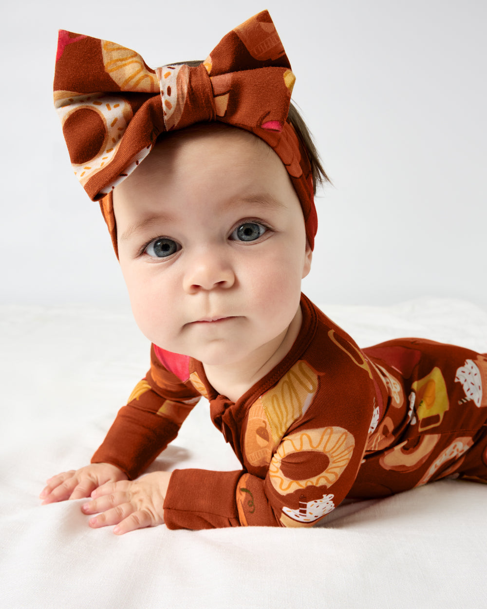 Baby on her tummy wearing the Harvest Sweets Luxe Bow Headband