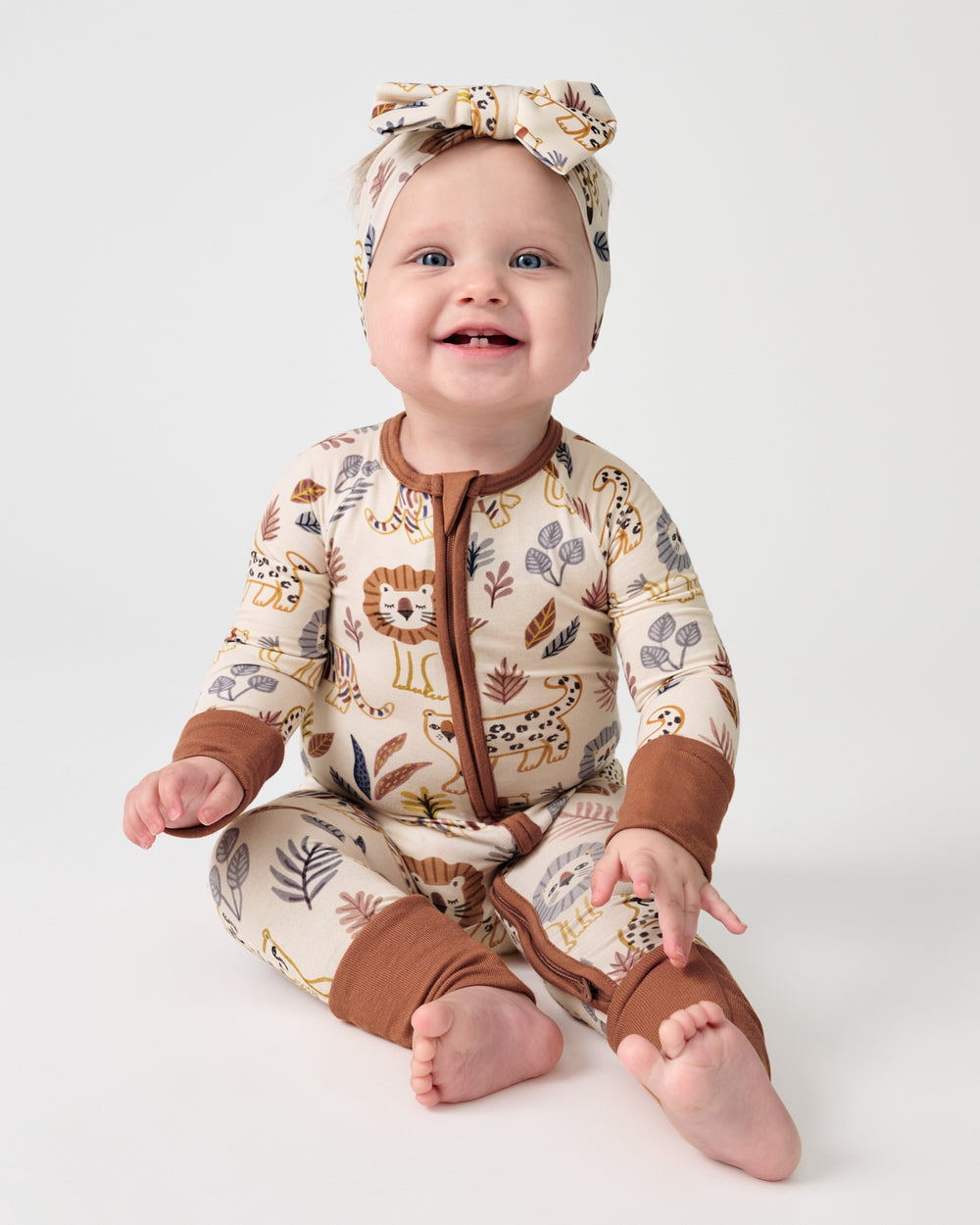 Sitting baby wearing the Savanna Friends Zippy and Luxe Bow Headband