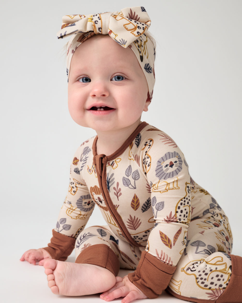 Baby wearing the Savanna Friends Luxe Bow Headband and Zippy