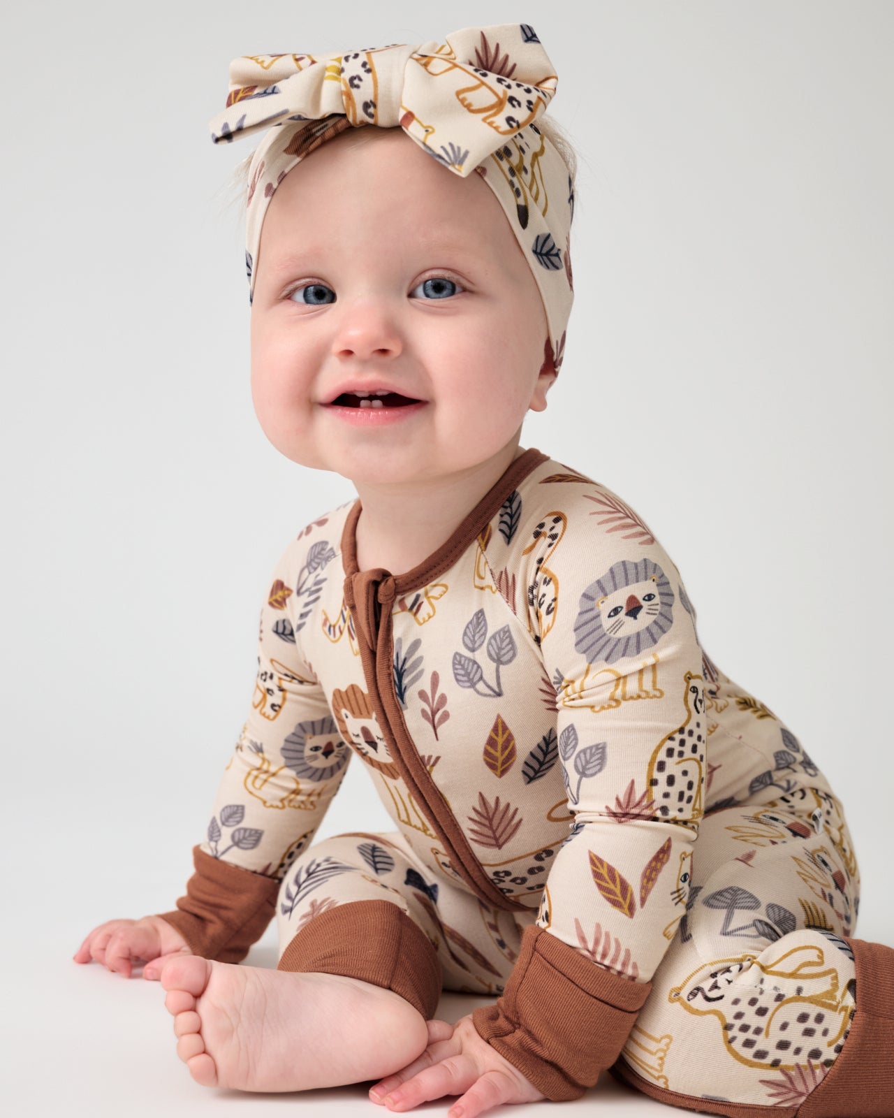 Baby wearing the Savanna Friends Luxe Bow Headband and Zippy