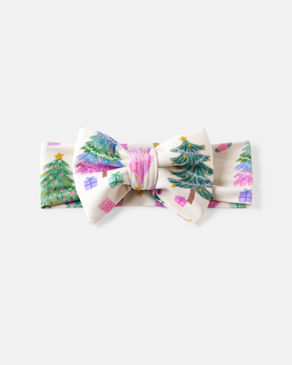A fabric bow tie featuring a Christmas tree and gift pattern on a cream background, photographed against a light gray studio background.