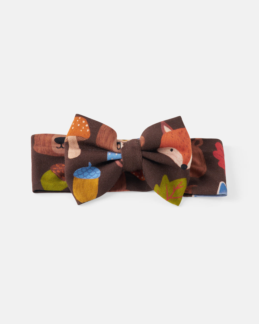 A kids' fabric bow tie and matching headband set featuring a woodland forest print with a fox, mushrooms, acorns, and leaves on a dark brown background, shown against a light gray studio backdrop.