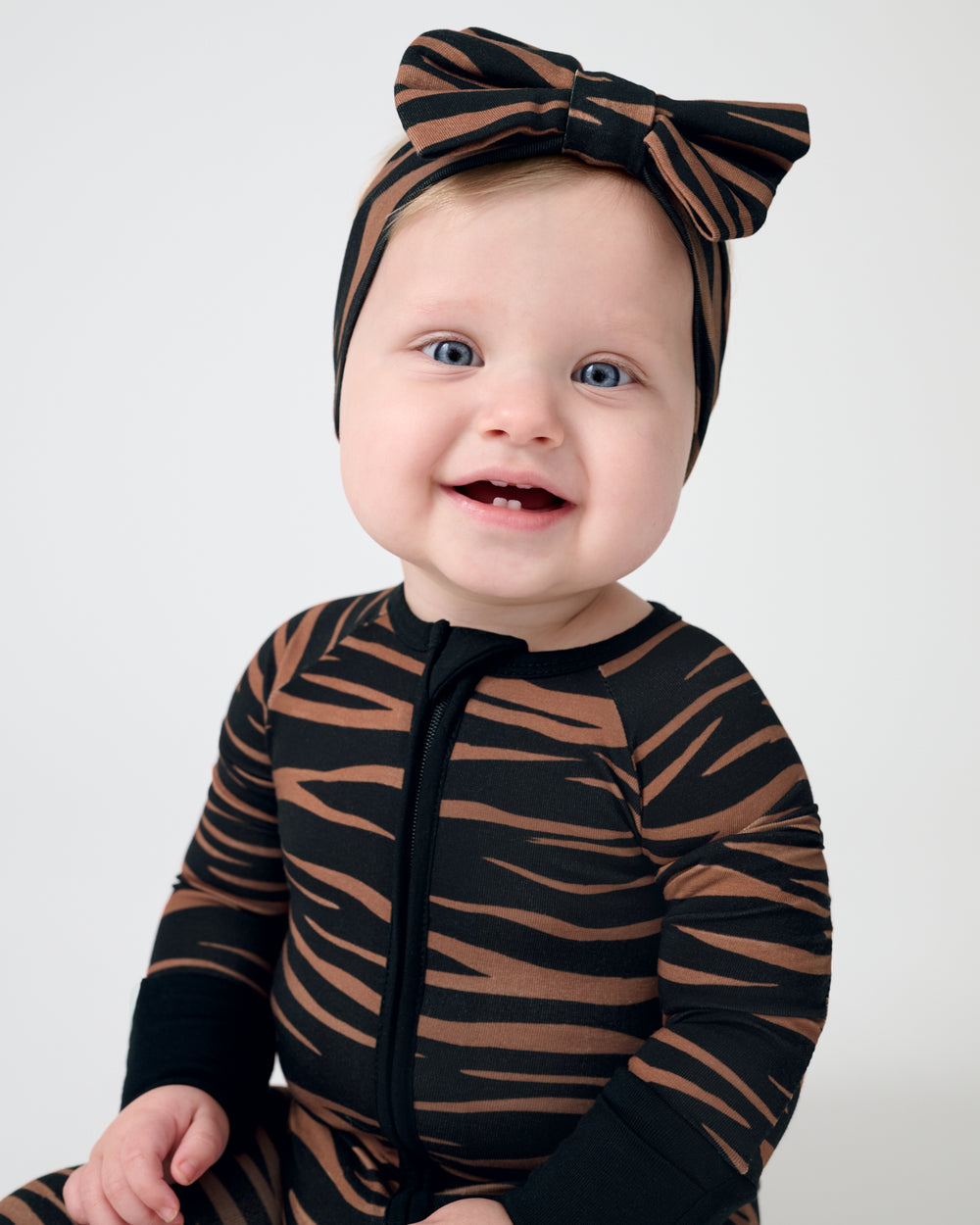 Close up of baby wearing the Wild Stripes Luxe Bow Headband